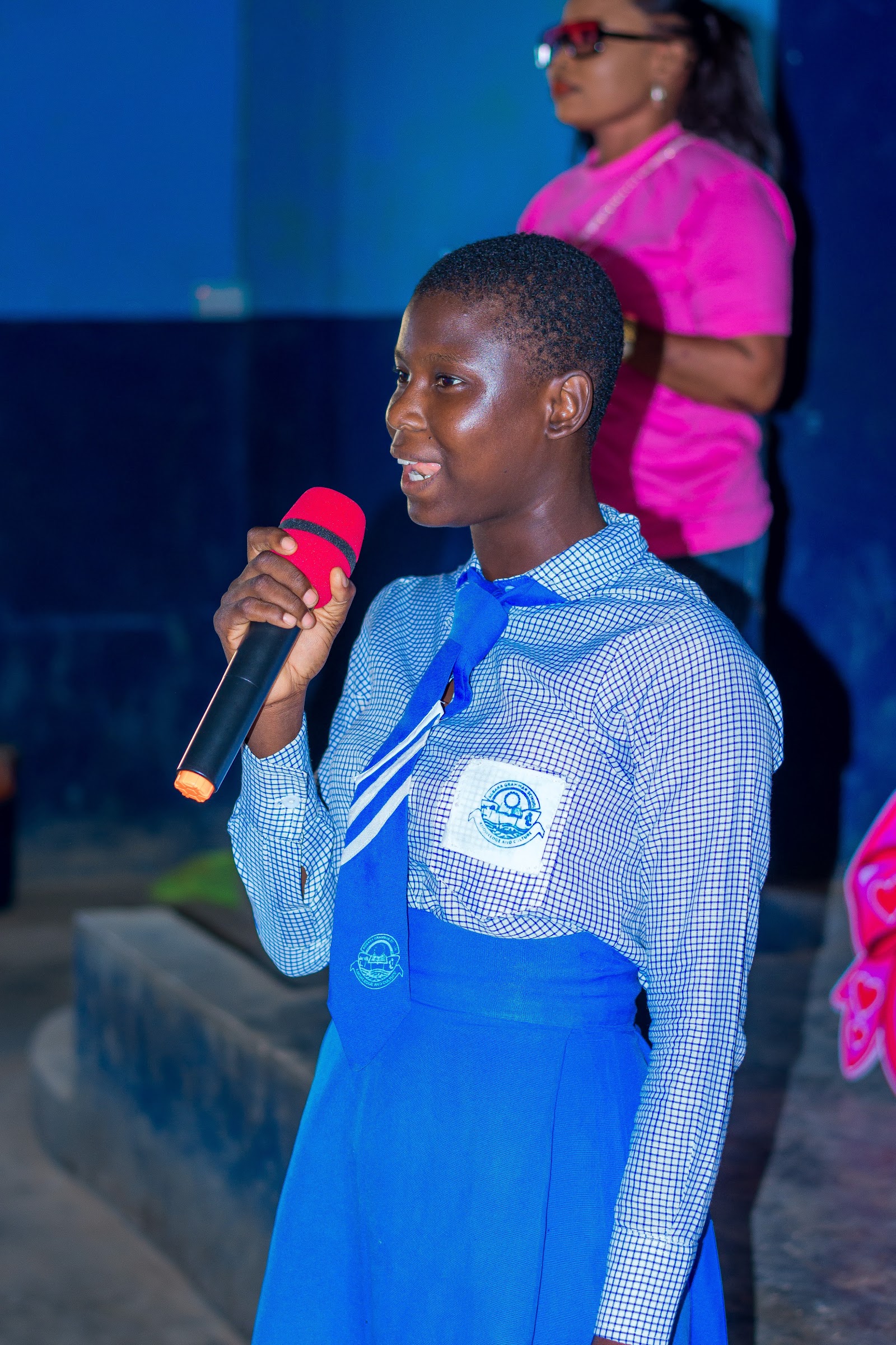 A student takes the microphone during World Girl Child Day at Agbara Grammar School