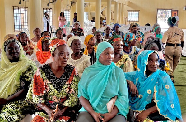Widows seated together at a foundation gathering inside the hall